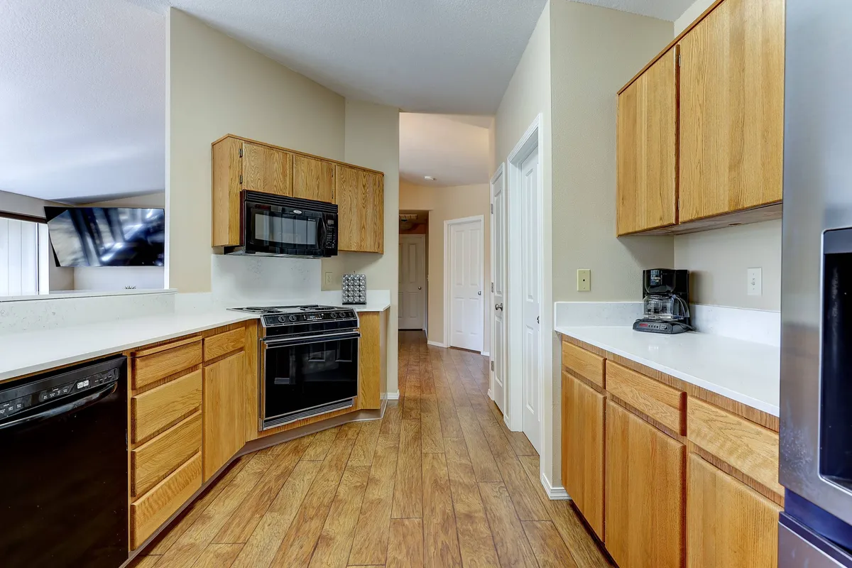 A bright, updated kitchen with modern appliances, generous counter space, and sleek cabinetry. The scene highlights stainless steel appliances, a spacious countertop perfect for meal prep, and warm lighting that invites culinary activity and conversation.